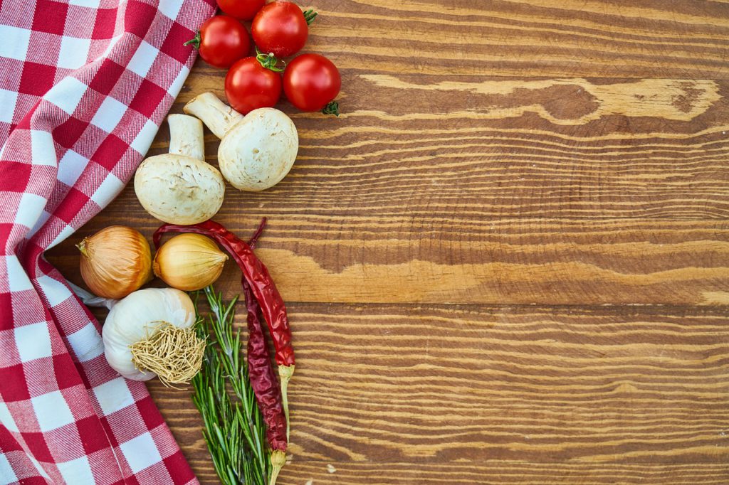 Picnic Table with tomato, onions, and spices.