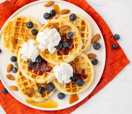 I’m Makin’ Waffles Bundle A large plate of waffles, blueberry, honey, and whipped cream.