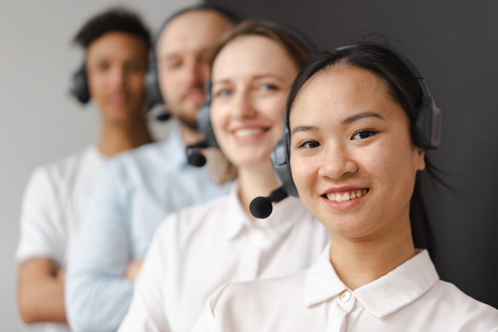 4 customer service agents standing in a line.