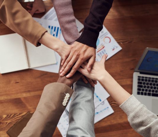 13 Top Employee Benefits Most Sought After in 2024 Hands place together in the center. Team work.