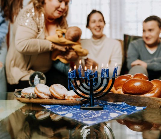 Celebrating The 2000 Year Old Traditions Of Hanukkah Family celebrating Hanukkah