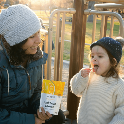 Mother and daughter enjoying jackfruit chew snack