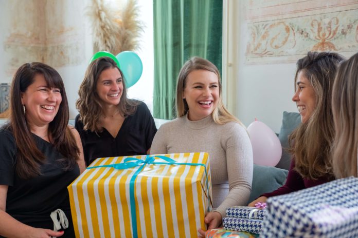 A group of friends unwrapping gifts