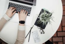 10 Onboarding Gift Ideas for Employees Who Just Joined the Company An employee logging in to a remote work day with nearby office supplies and a plant nearby.