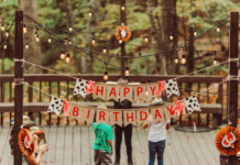 Birthday Gift Ideas for Everyone on Your List A backyard birthday scene with decorations and lights.