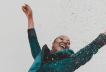 7 Occasions to Treat Yourself and Others A woman celebrating and jumping in the air with confetti.