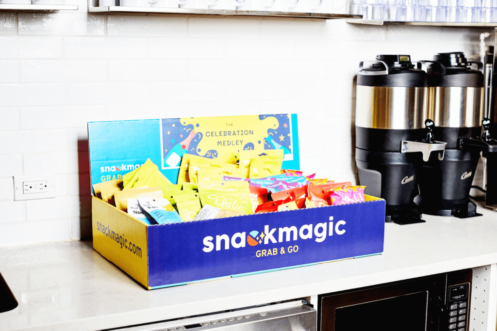 A huge SnackMagic Grab & Go Box in a shared workplace kitchen with a load of snacks and sips to share.